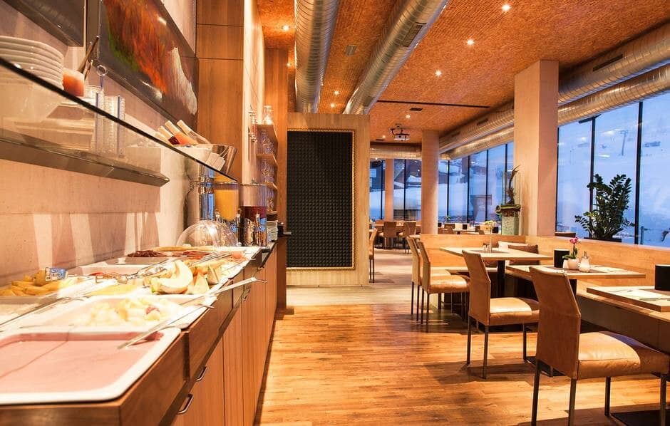 Breakfast buffet area and dining room with floor-to-ceiling mountain views