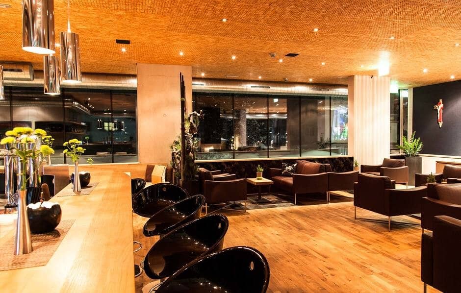 Lounge area with bar seating and floor-to-ceiling windows