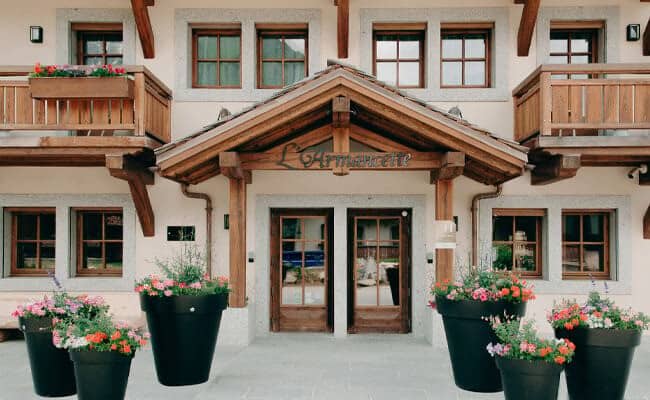 Chalet entrance with covered timber porch and private balconies