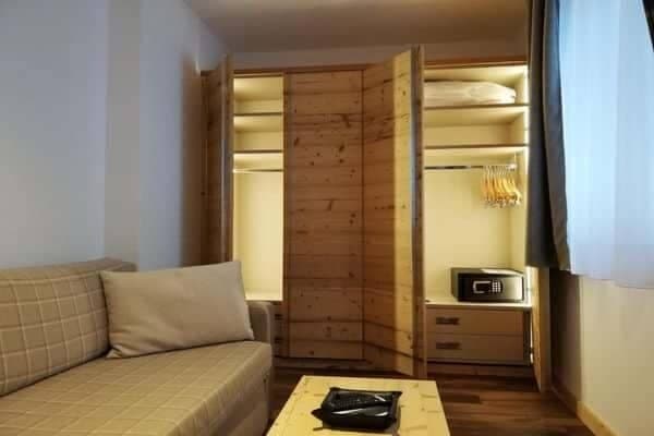 Built-in wardrobe with interior lighting, digital safe, and shelving