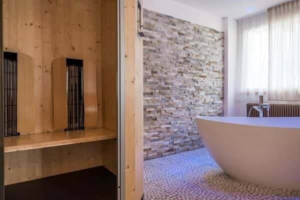 Bathroom with freestanding soaking tub and private wood-paneled sauna