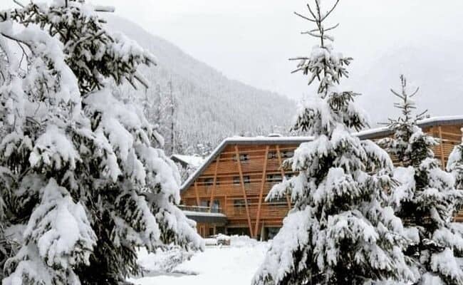 Timber chalet exterior with private balconies and mountain views