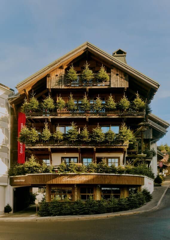 Timber-framed chalet with tiered private balconies and ground-floor restaurant