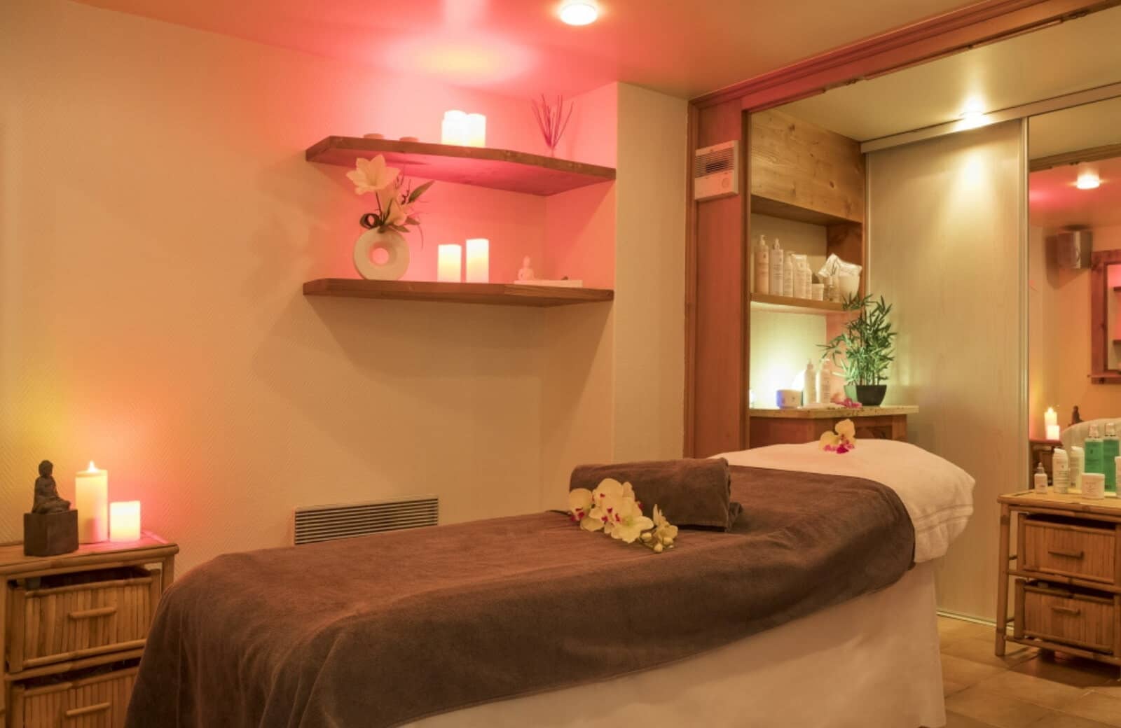 Private spa room with massage table and mirrored storage closets