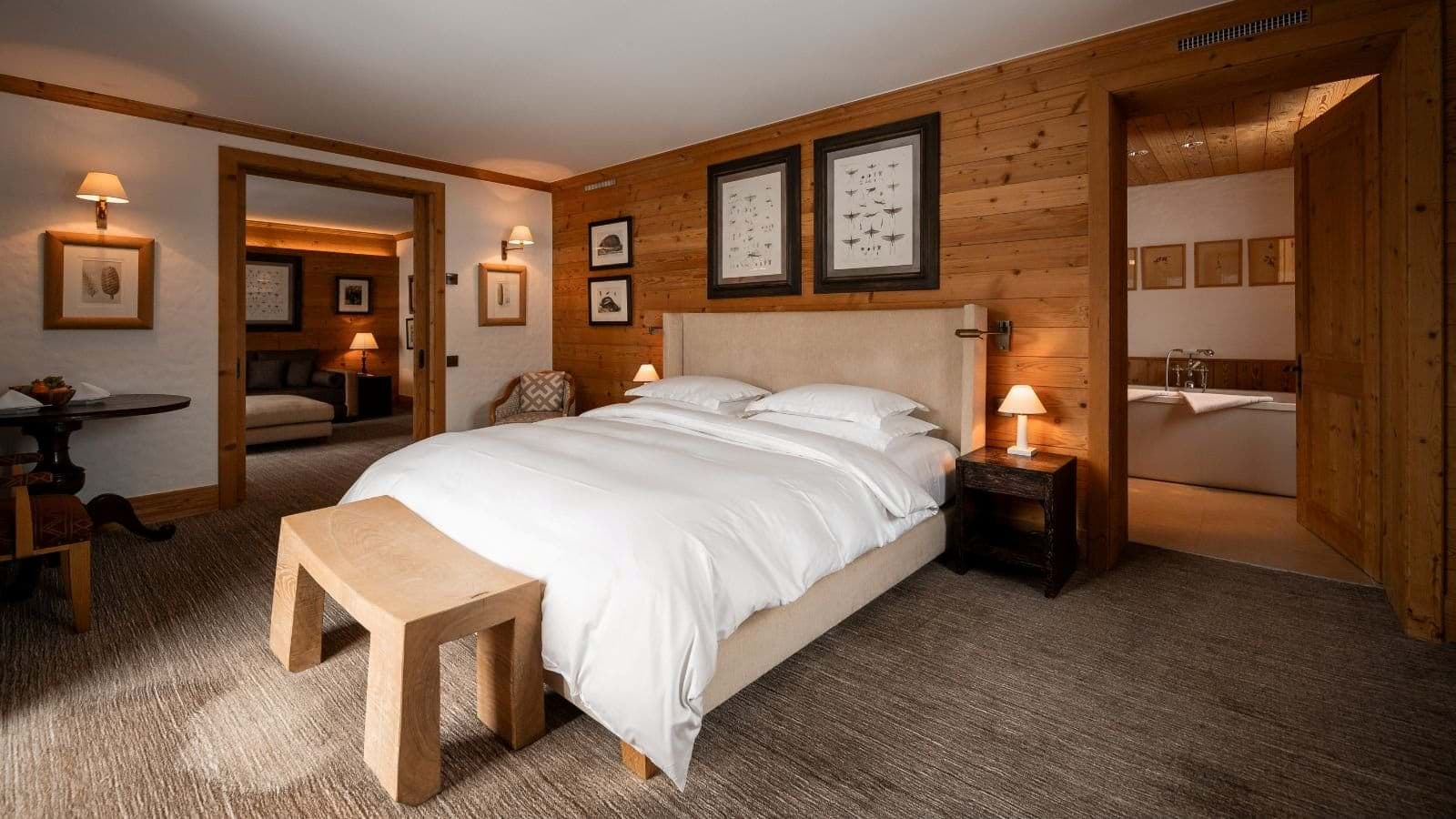 Primary bedroom with king bed, en-suite bathroom, and adjoining sitting area