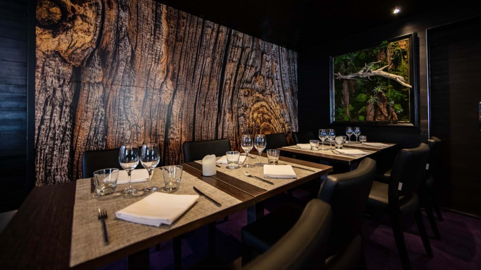 Dining area with wood-grain mural and seating for 10