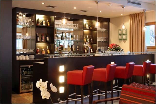 Private cocktail bar with seating for five and integrated beverage cooler