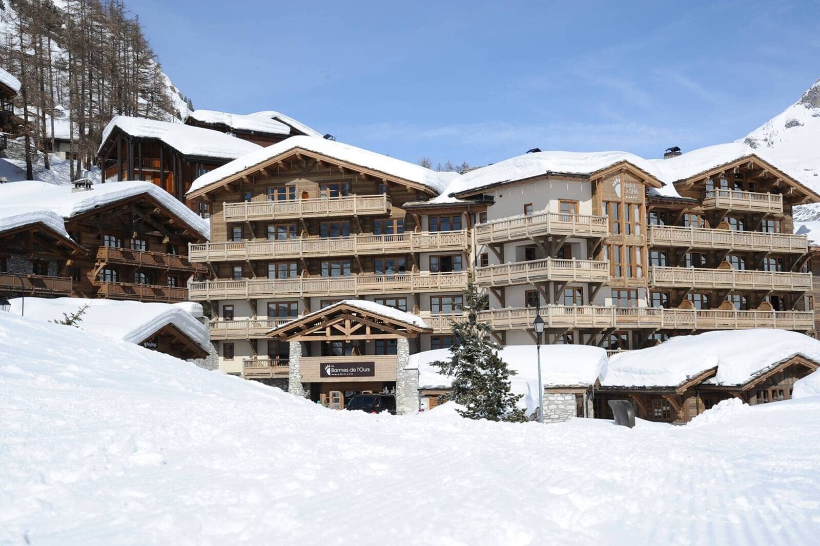 Ski-in/ski-out chalet exterior with multi-level private balconies and on-site spa