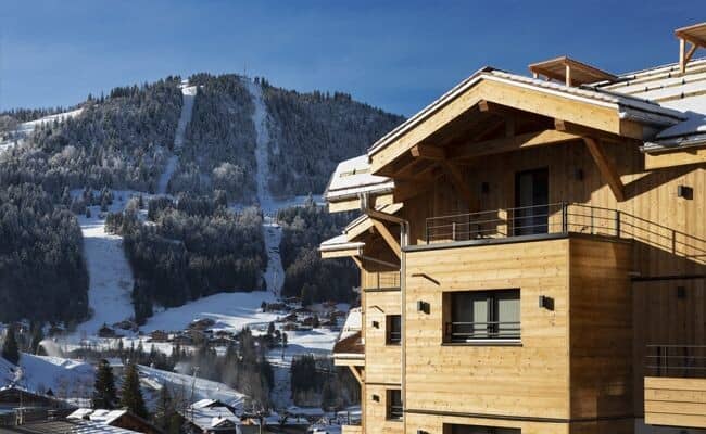 Chalet exterior with private balconies and direct ski slope views