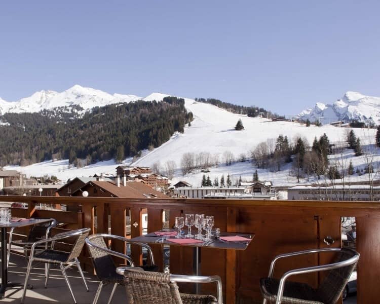 Private balcony with bistro seating and panoramic ski slope views