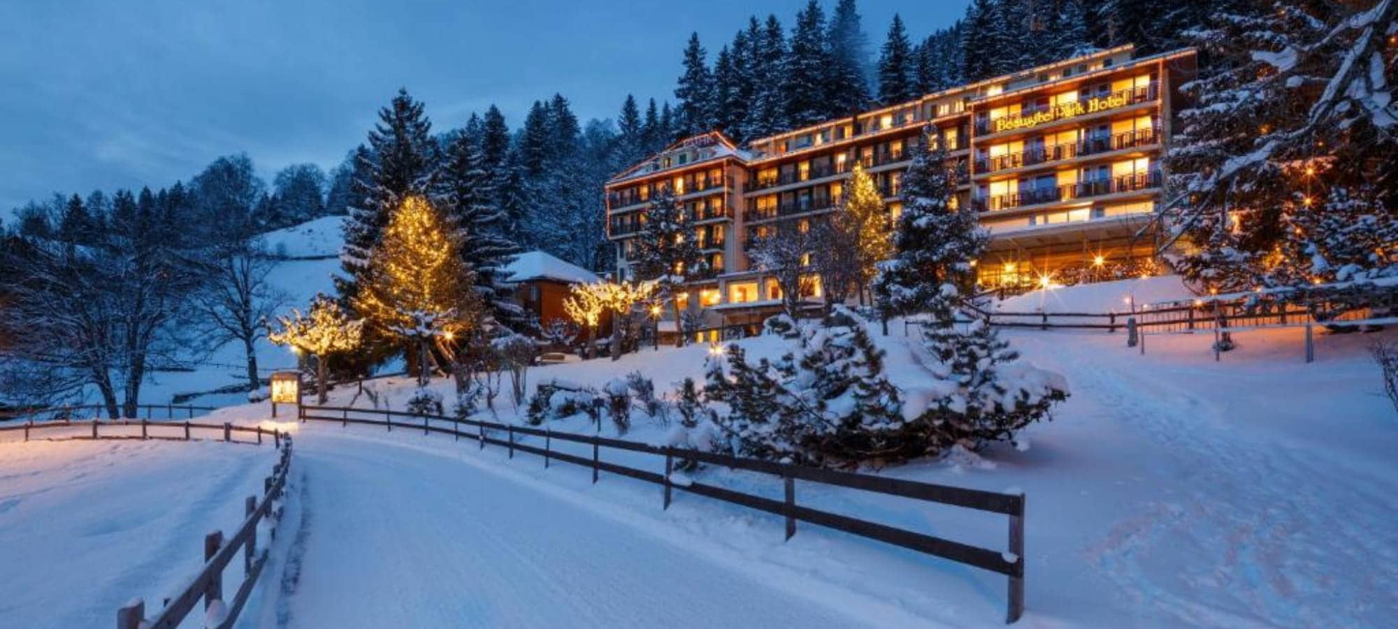Mountain-facing exterior with private balconies and illuminated grounds