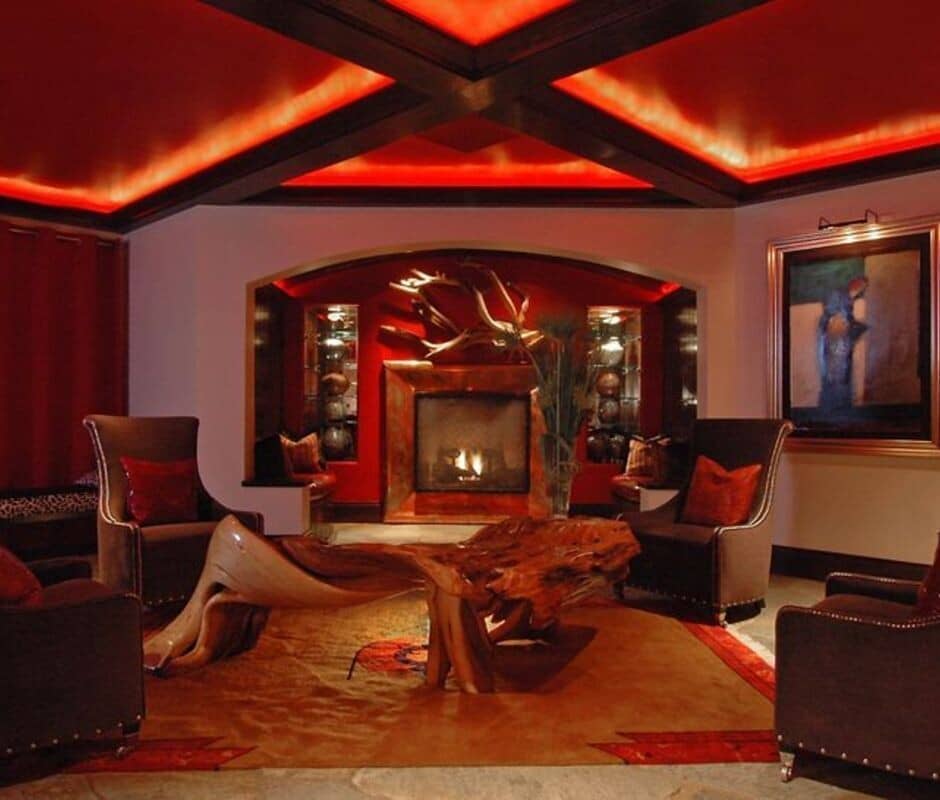 Sitting area with wood-burning fireplace and coffered ceiling with cove lighting