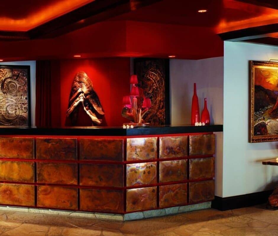 Custom reception desk with hammered copper panels and flagstone flooring