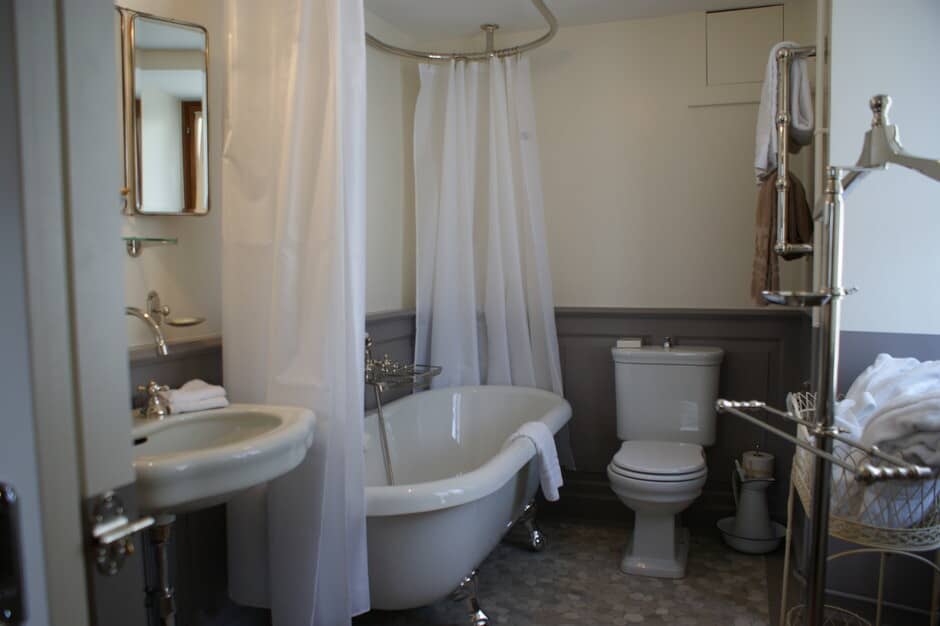 Bathroom with clawfoot soaking tub and overhead shower ring