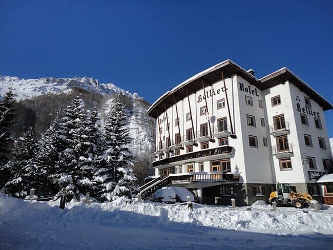 Hotel exterior with private balconies and mountain views