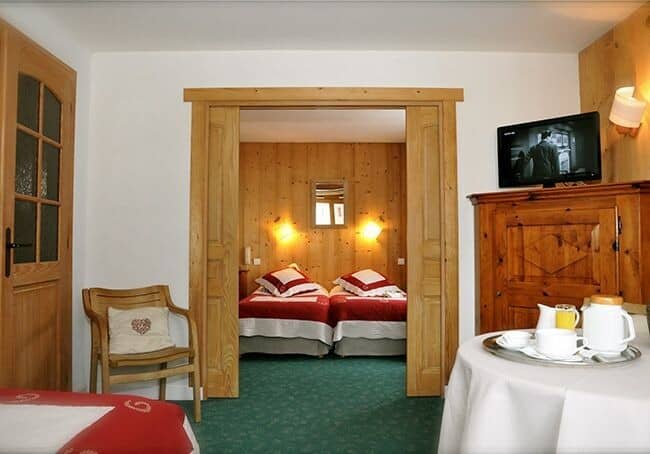 Guest suite with twin beds and sliding wood privacy doors