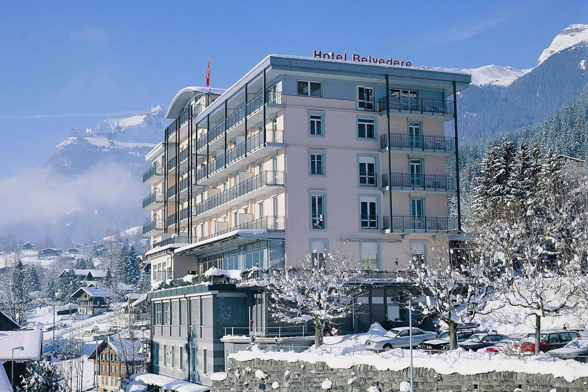 Hotel exterior with private balconies and snow-covered mountain views