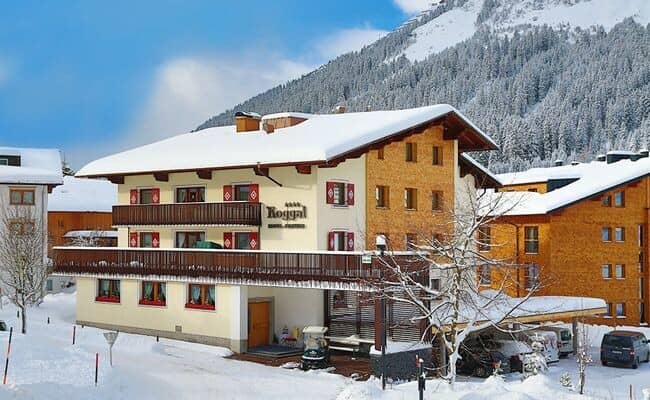 Chalet exterior with wrap-around balconies and covered parking area