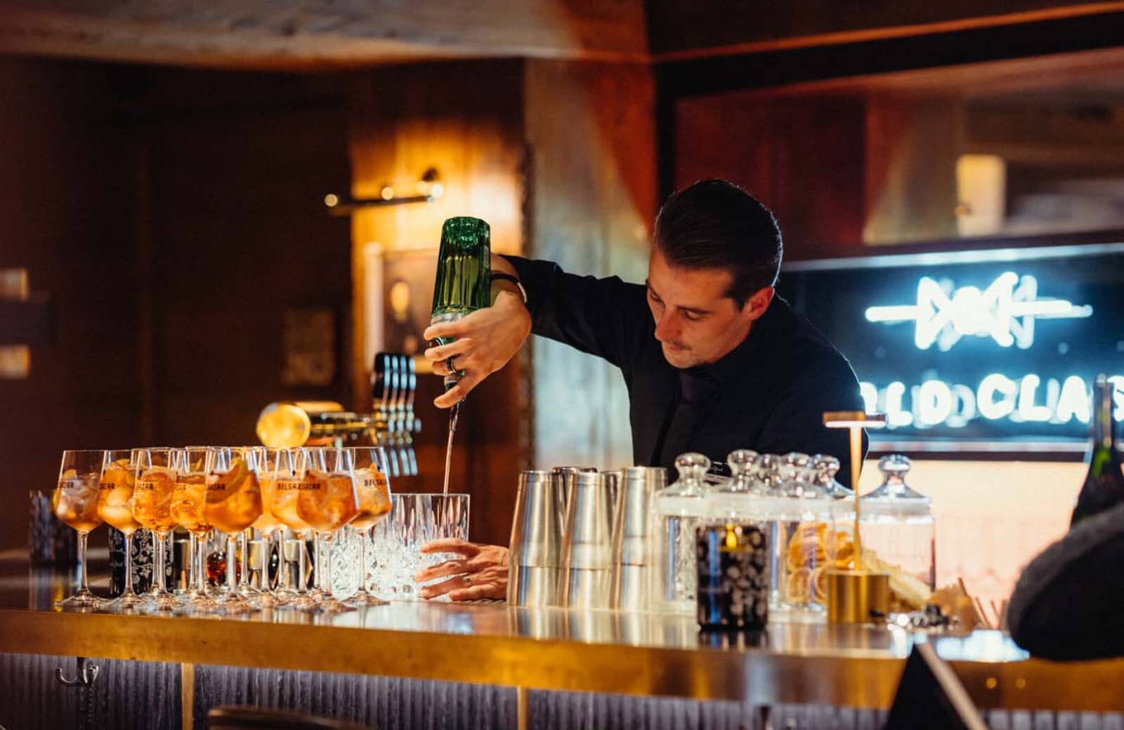 Private bar area with professional cocktail service and brass finishes