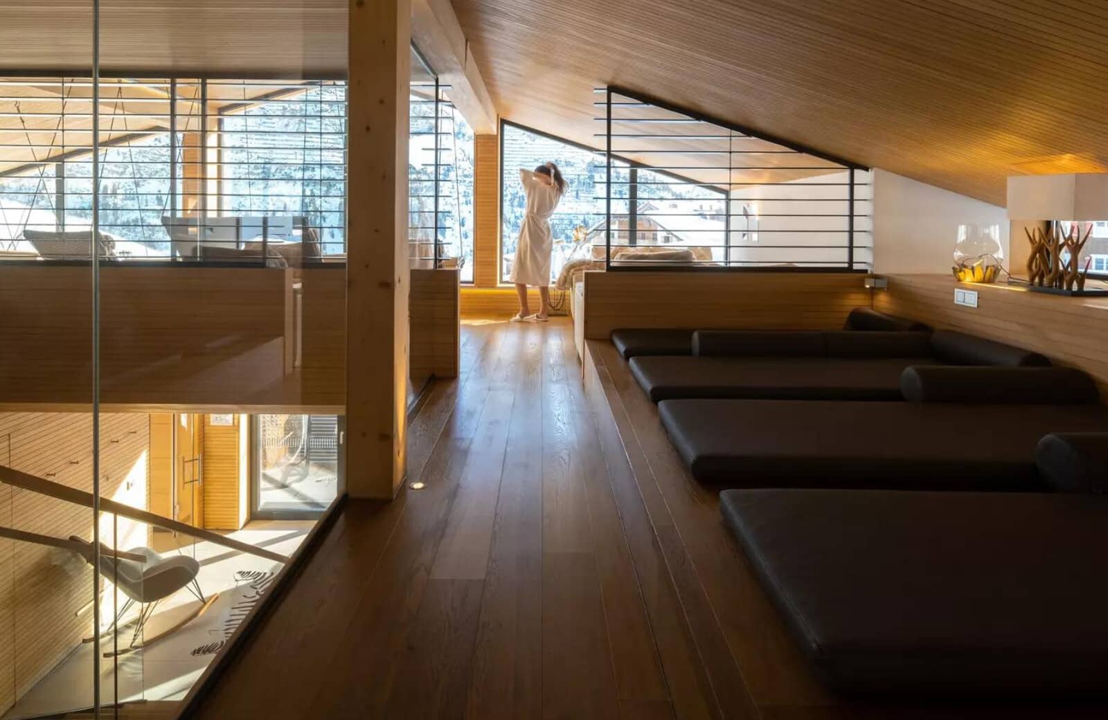 Mezzanine relaxation area with four floor mattresses and snowy mountain views