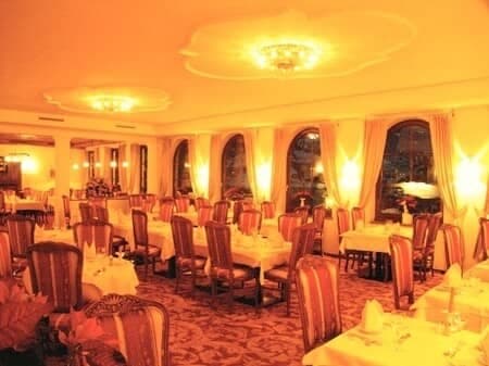 Formal dining room with seating for 30 and arched windows