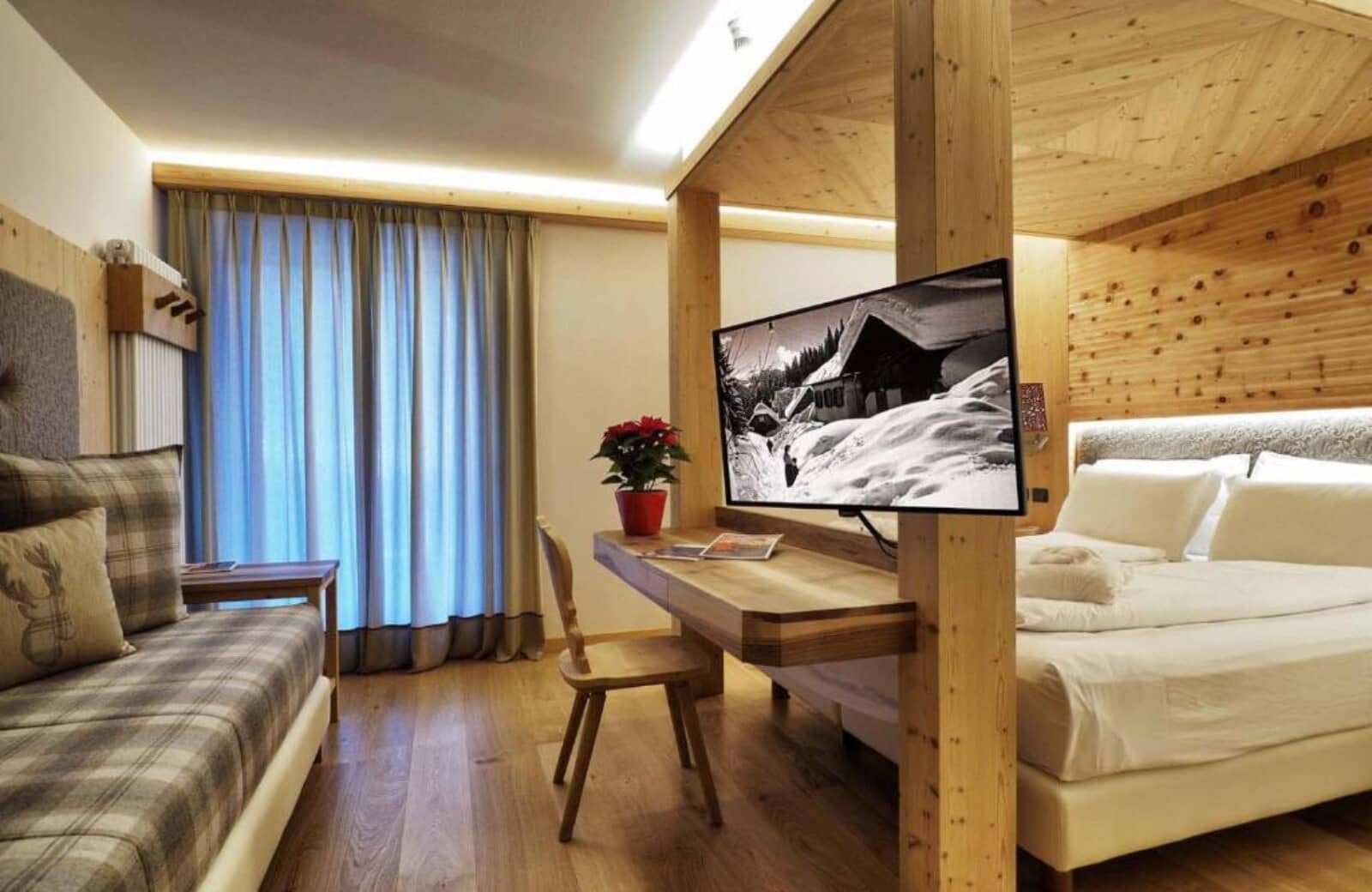 Queen bed alcove with built-in desk and swivel-mount TV