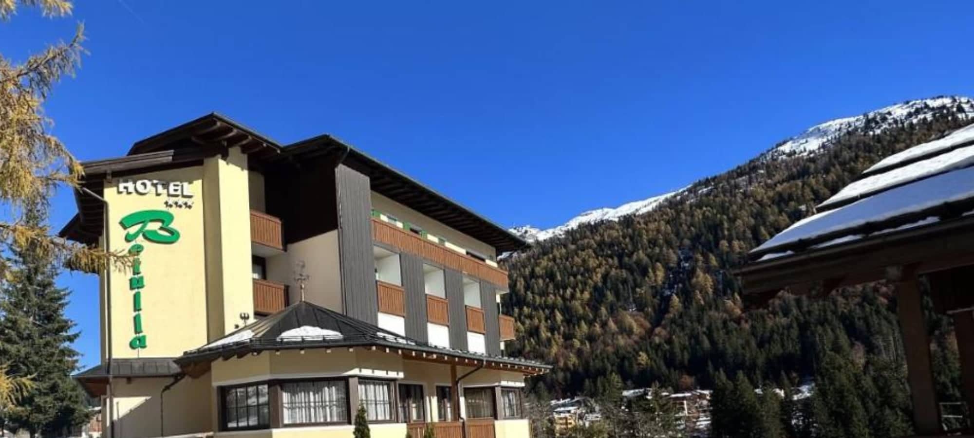 Hotel exterior with private balconies and alpine mountain views