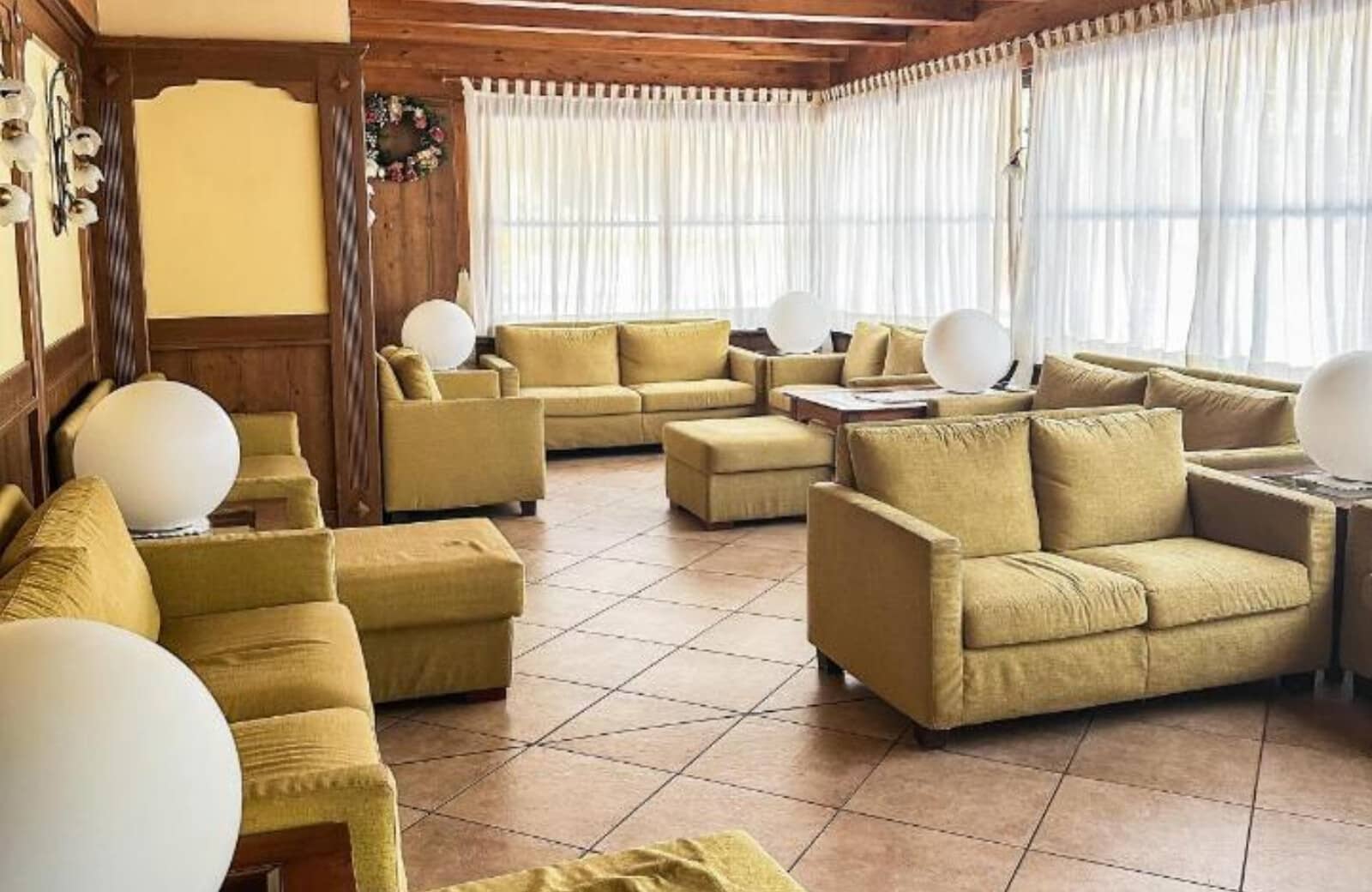 Lounge area with multi-sofa seating for 15 and tiled flooring