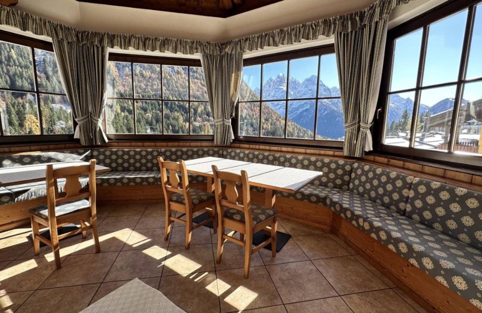 Dining nook with banquette seating and panoramic mountain views