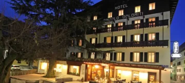 Hotel exterior with private balconies and ground-floor terrace seating