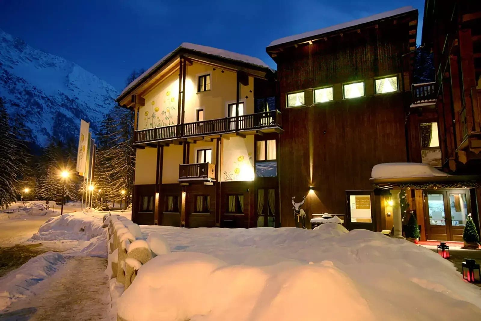Chalet exterior with private balconies and mountain views at dusk