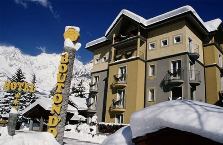 Building exterior with private balconies and snow-covered mountain views