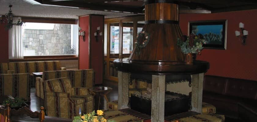 Lounge area with central 360-degree wood-burning fireplace and booth seating