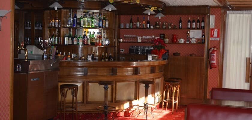 Private wood-paneled bar with draught beer tap and stool seating