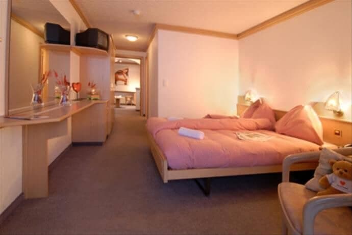 Guest bedroom with two twin beds and built-in vanity desk