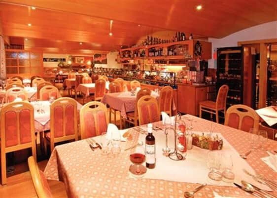 On-site restaurant with traditional wood paneling and wine storage