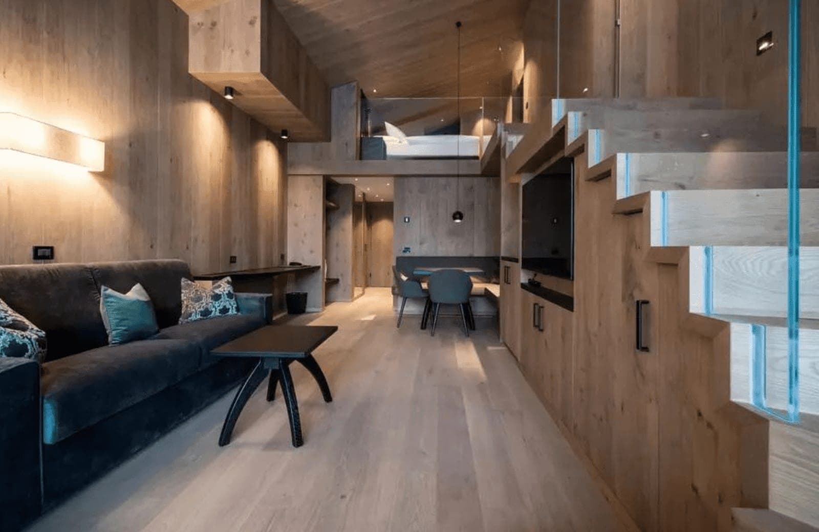 Open-plan living area with built-in dining nook and mezzanine sleeping loft