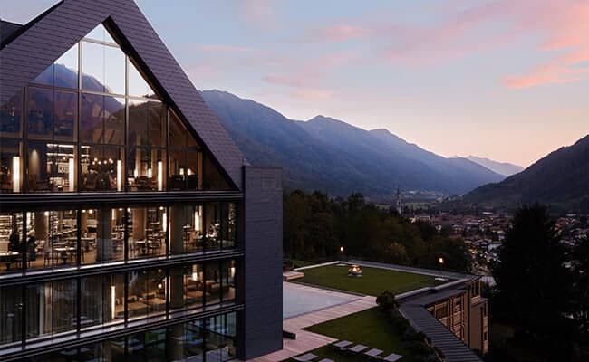 Floor-to-ceiling windows and outdoor terrace with valley sunset views