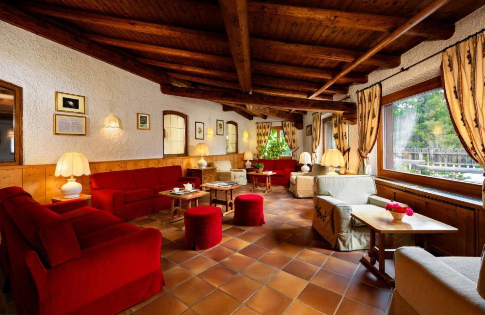 Lounge with exposed timber beams and seating for 12