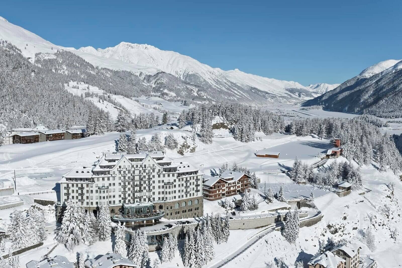 Aerial view of snow-covered resort with Alpine mountain backdrop