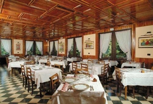 Dining room with coffered wood ceiling and checkered tile flooring