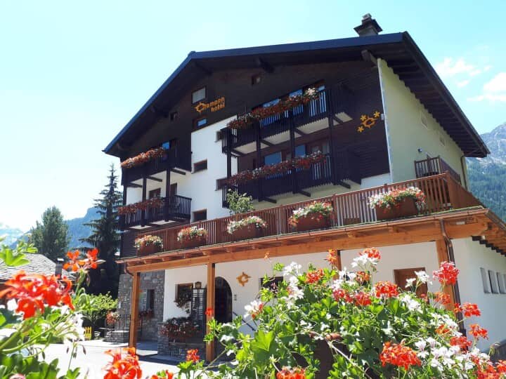 Chalet exterior featuring private balconies and flower-lined sun terrace