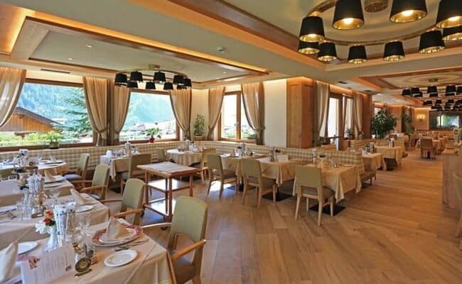 Dining room with booth and chair seating; mountain valley views