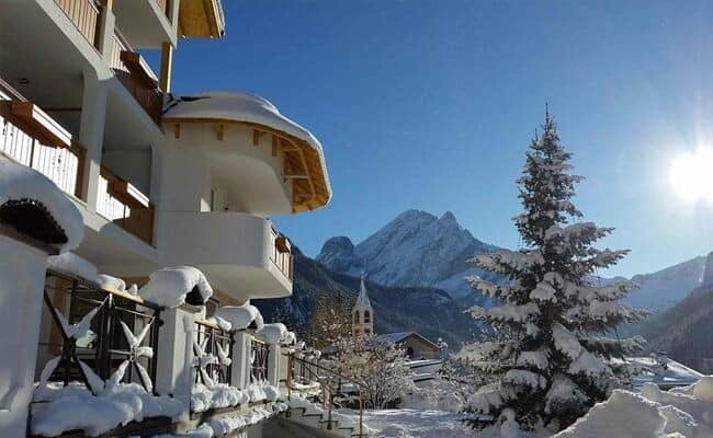 Building exterior with private balconies and views of the Dolomite mountains