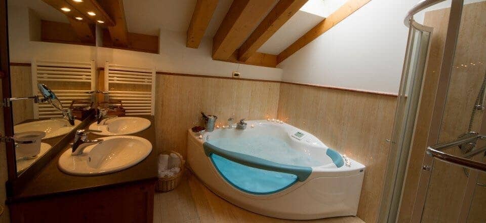 Bathroom with dual vanity, jetted soaking tub, and walk-in shower