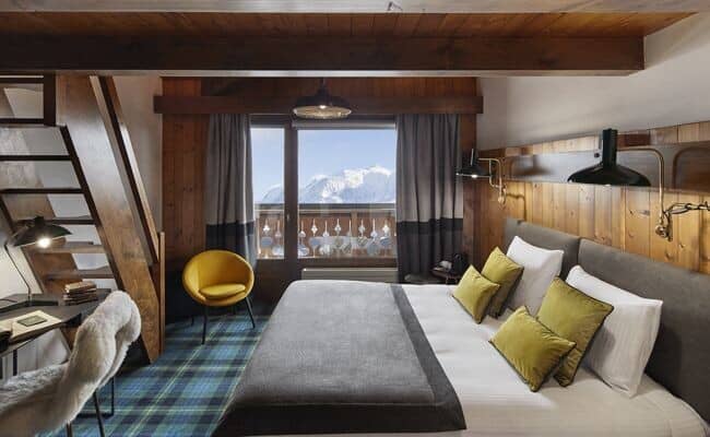 Bedroom with king bed, mountain views, and stairs to loft area