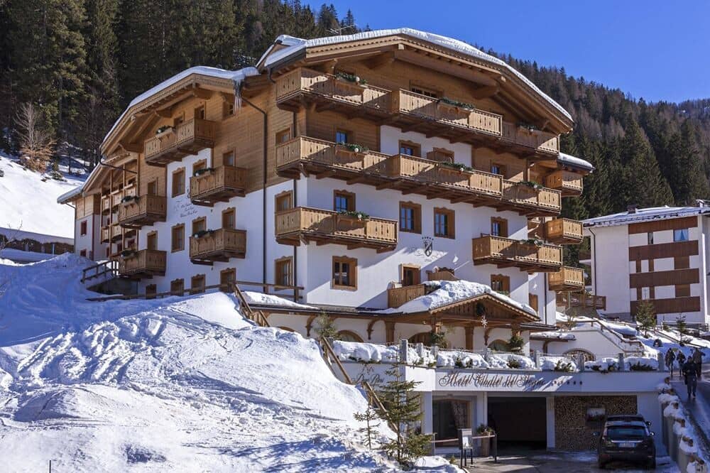 Chalet exterior with private balconies and covered parking garage