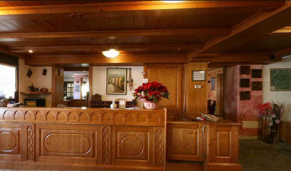 Lobby reception desk with hand-carved wood paneling and mail slots
