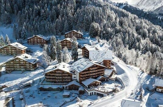 Aerial view of slope-side chalet complex with ski-in, ski-out access