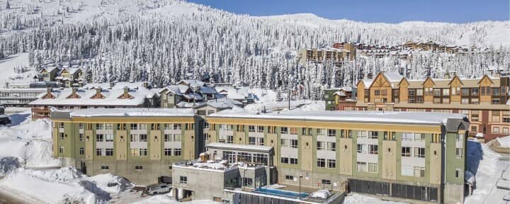 Ski-in/ski-out resort exterior with outdoor heated pool and mountain views